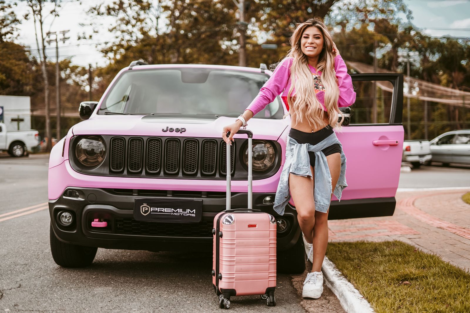 A chauffeur loading suitcases into an executive SUV before a cross-border Buffalo airport transfer