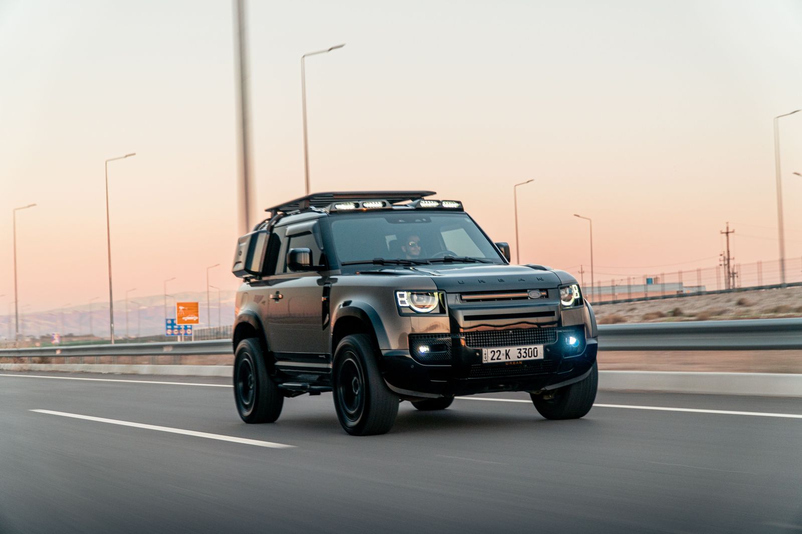 Black SUV on a highway at dusk, a typical vehicle for Hamilton airport transfers to Niagara
