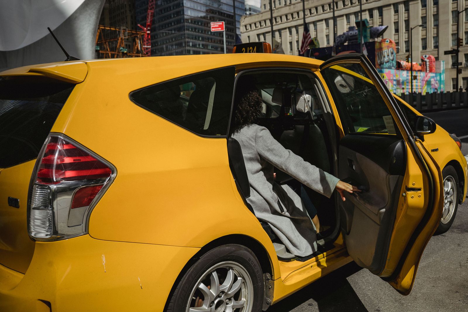 Chauffeur holding the rear door at a curbside pickup, the standard included service at YKF
