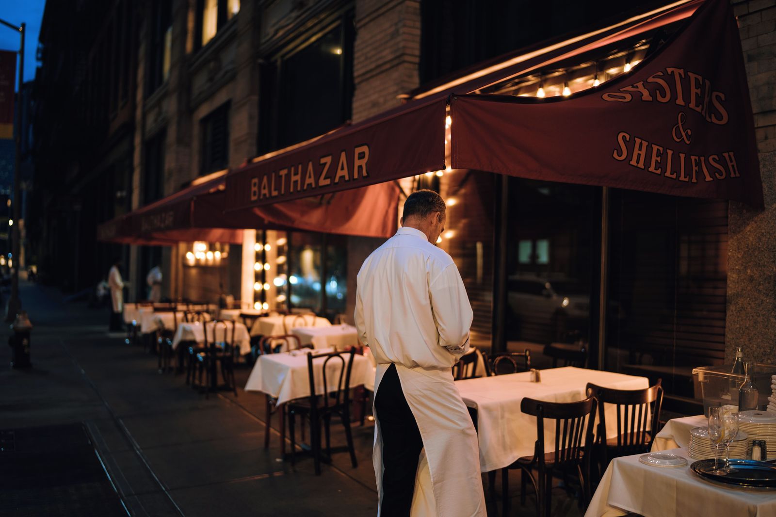 A Greek taverna patio on a summer evening