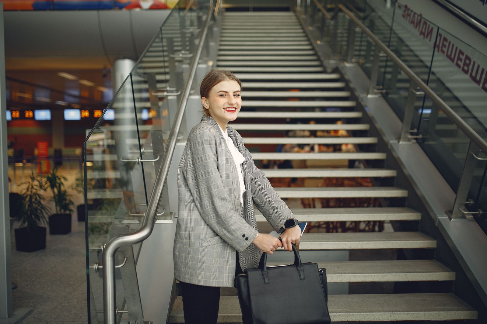 Business traveller on an airport escalator after a long-haul arrival