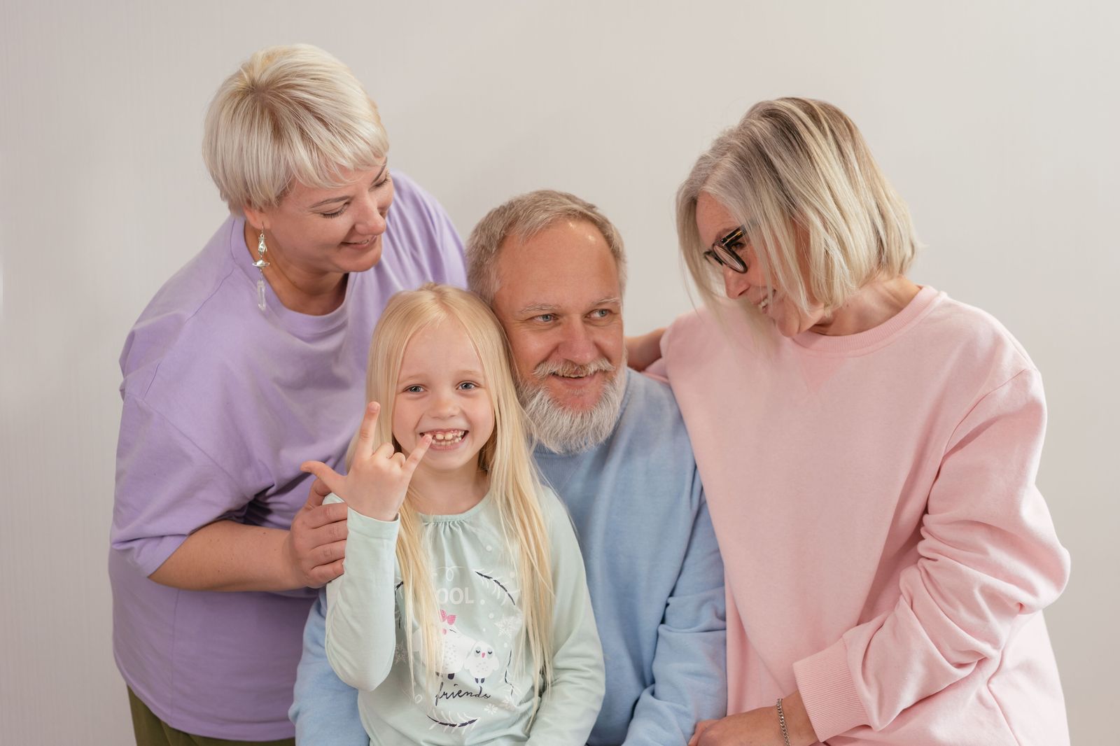 Grandparents greeting their family in an airport arrivals hall