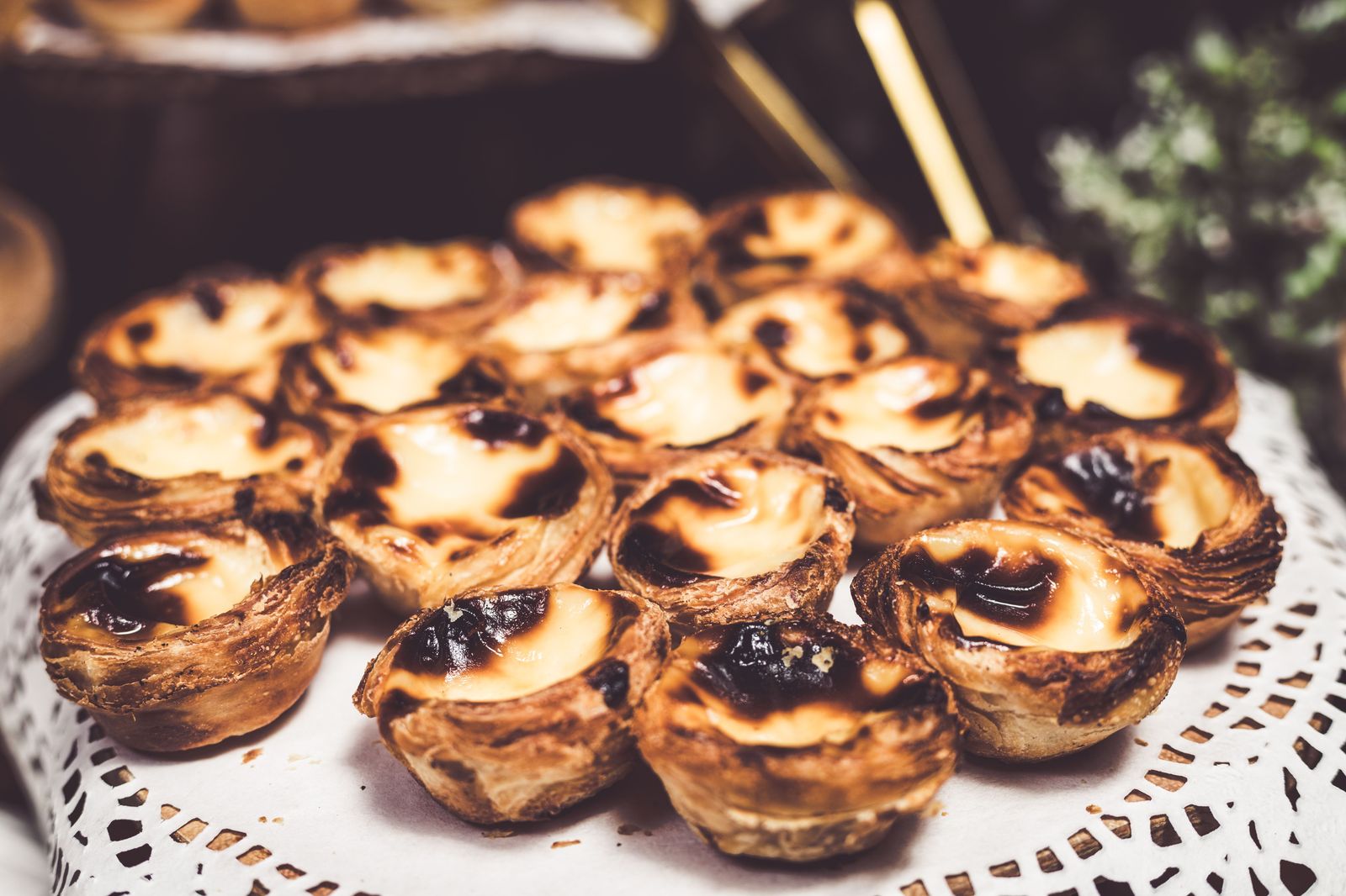A bakery counter lined with Portuguese custard tarts