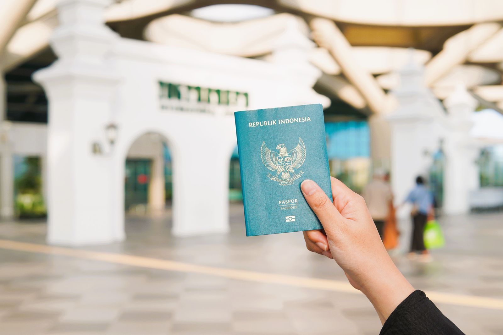 Travellers queuing at an airport passport control counter