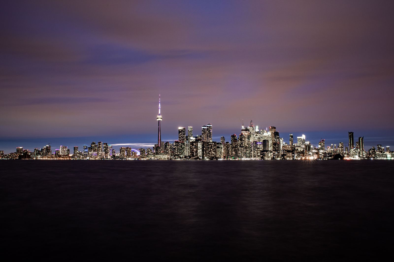 The waterfront skyline after dark, seen on the drive back along the Gardiner