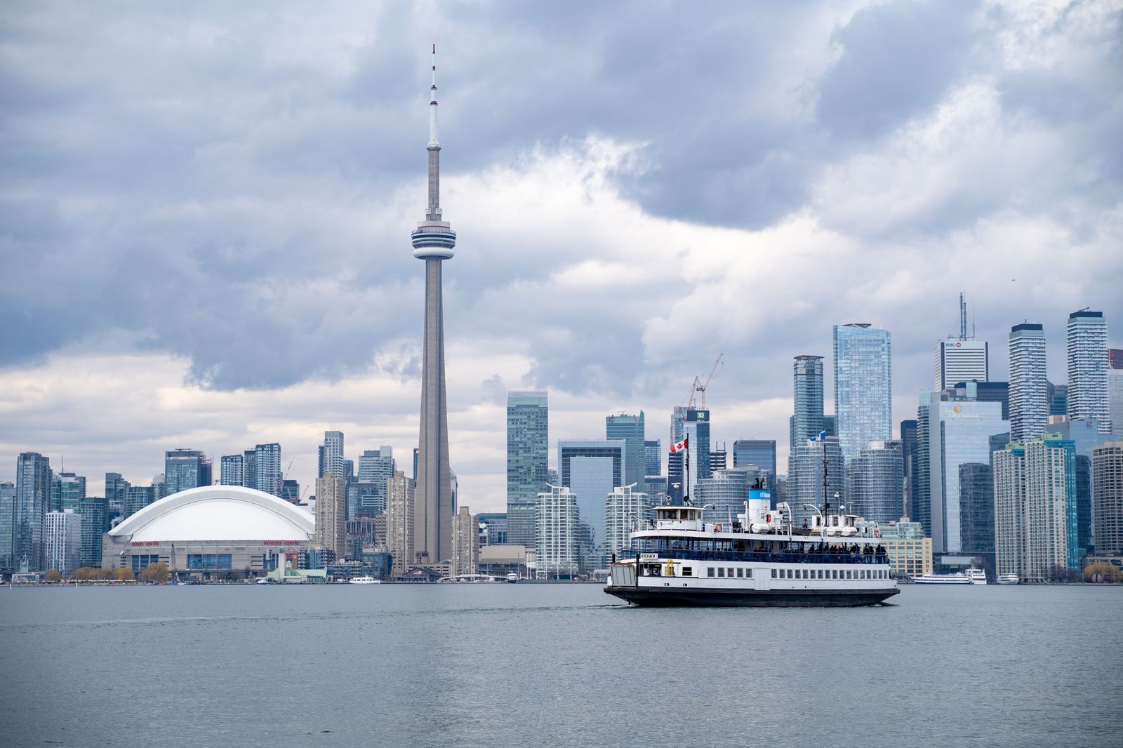 A city ferry crossing the inner harbour with the downtown skyline behind it