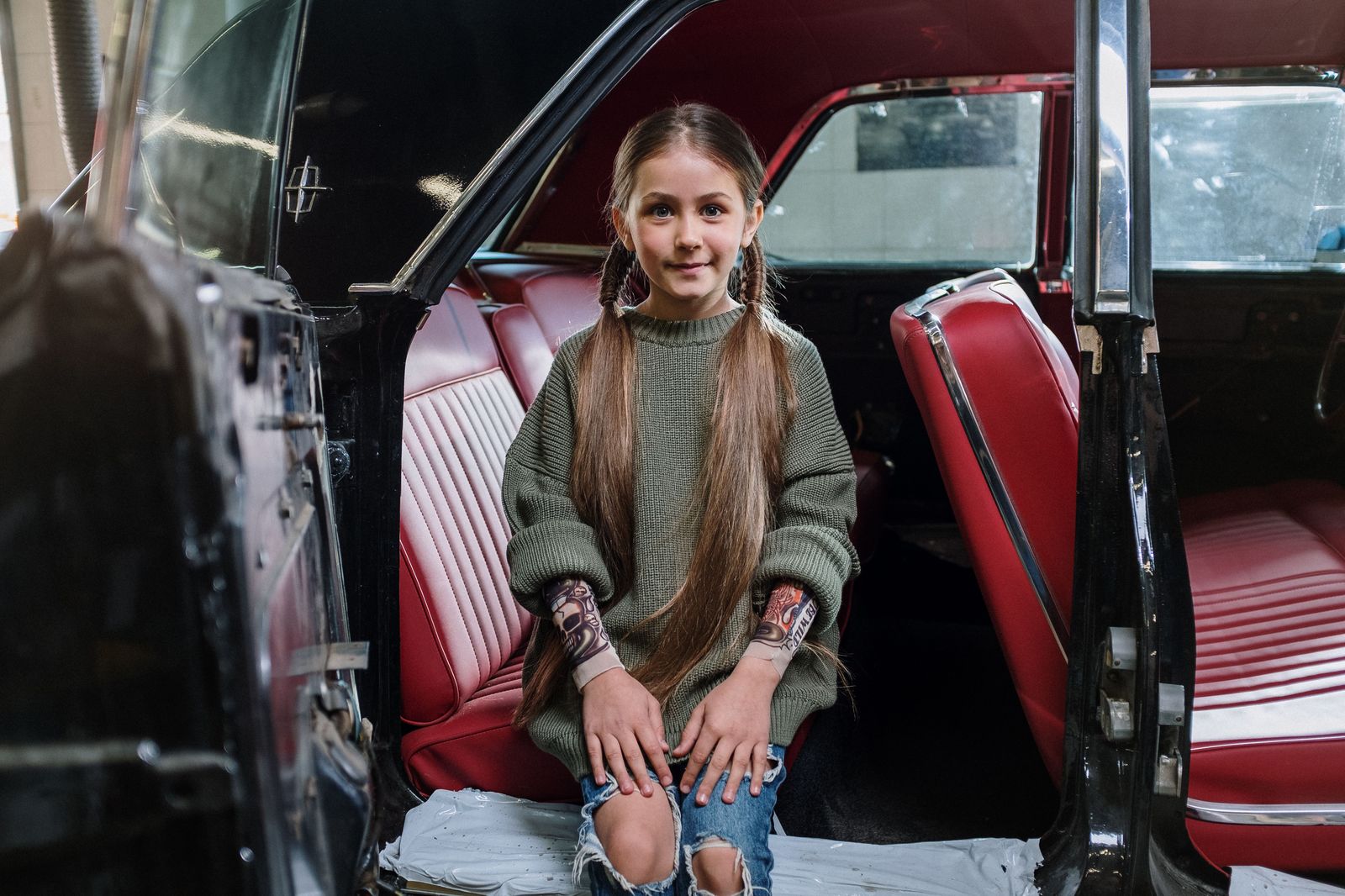 A child's car seat fitted in the back seat of a vehicle before an airport run