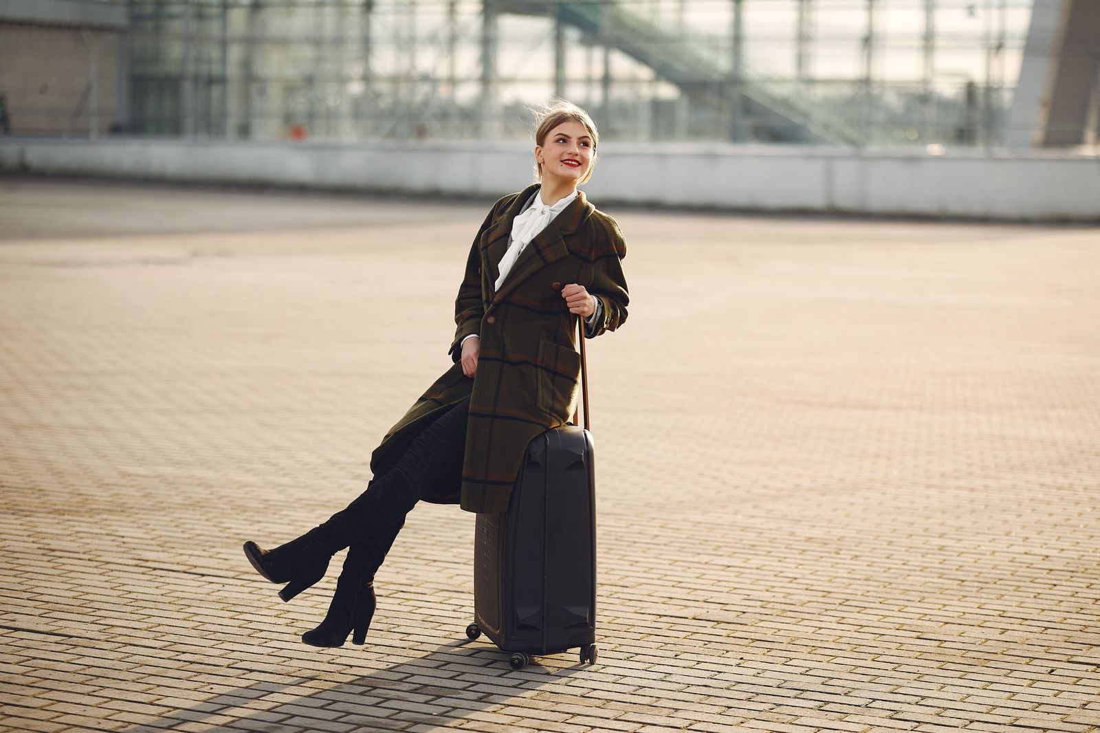 Suitcases at a departures curb, where a private transfer drops you at your airline's doors
