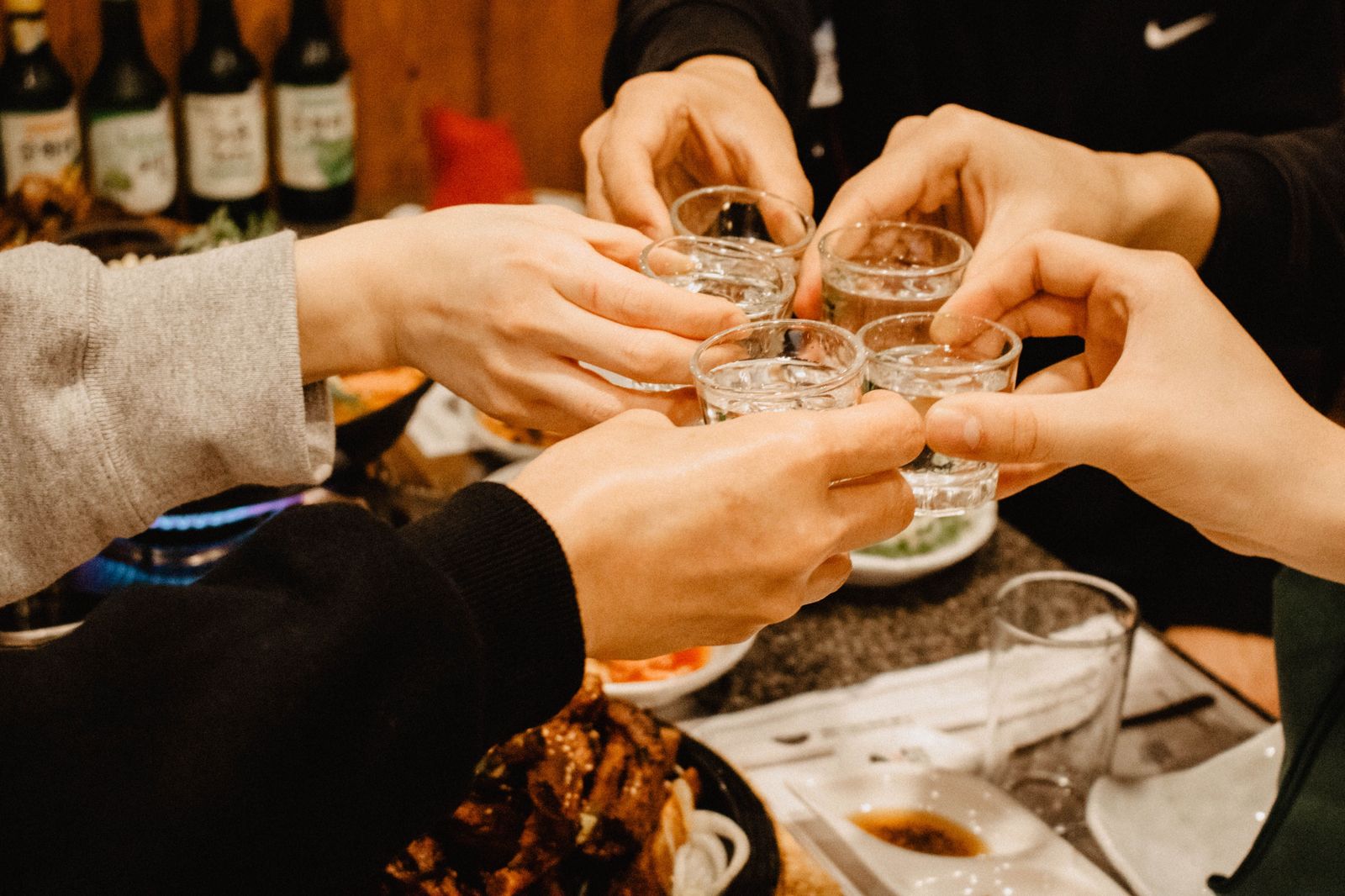 Friends raising glasses at a restaurant table during a night out