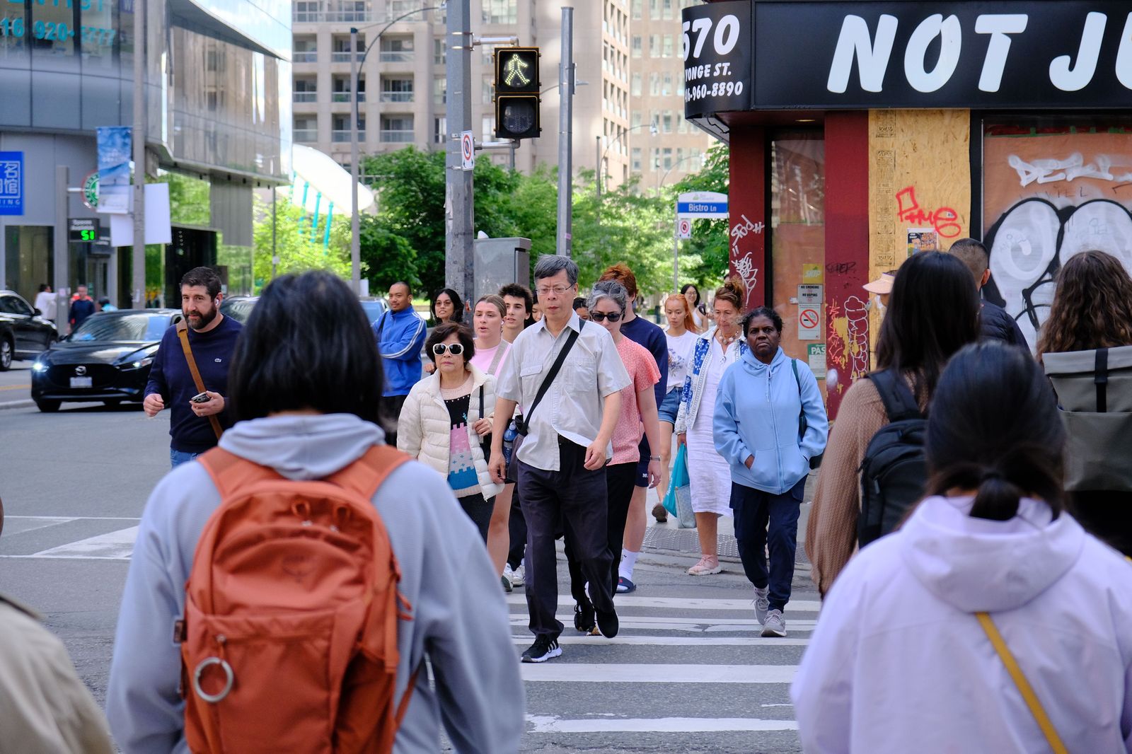 Pedestrians on a downtown Toronto street on a sunny afternoon