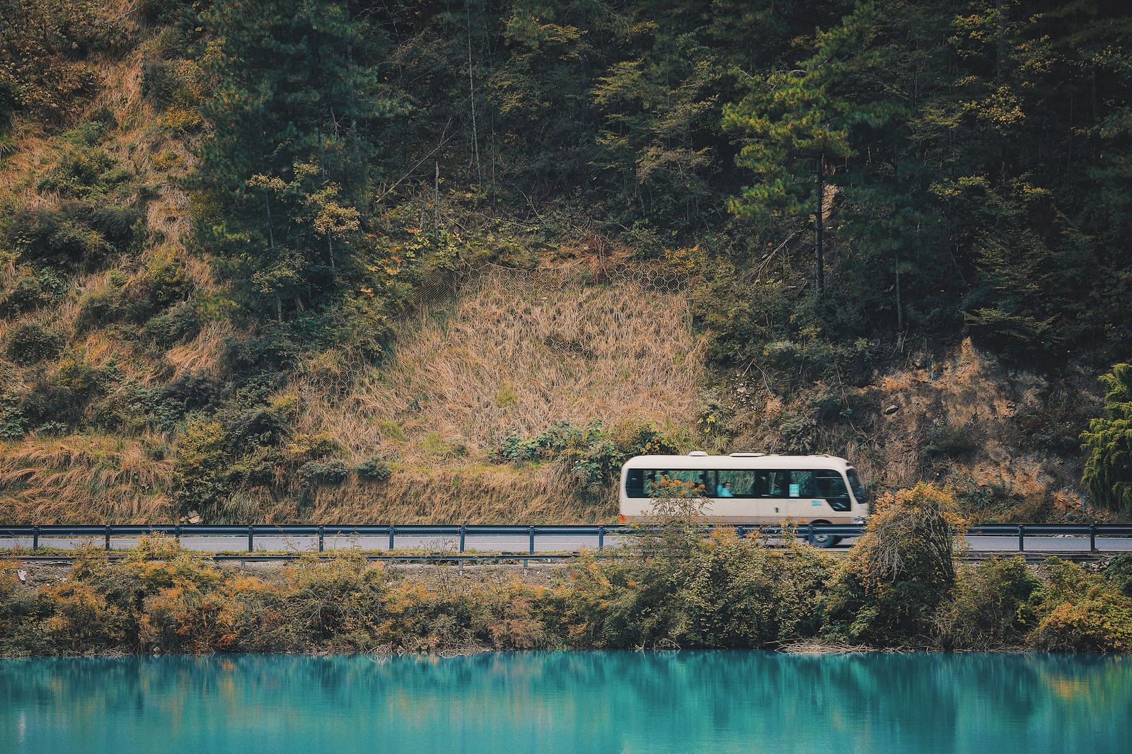 A coach travelling on the highway with a large group aboard