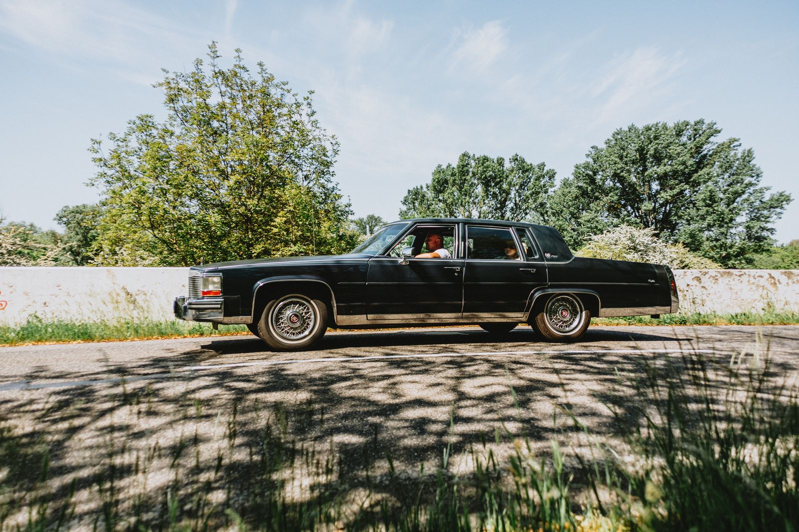 A black sedan on a rural highway through the farmland between Guelph and the 401
