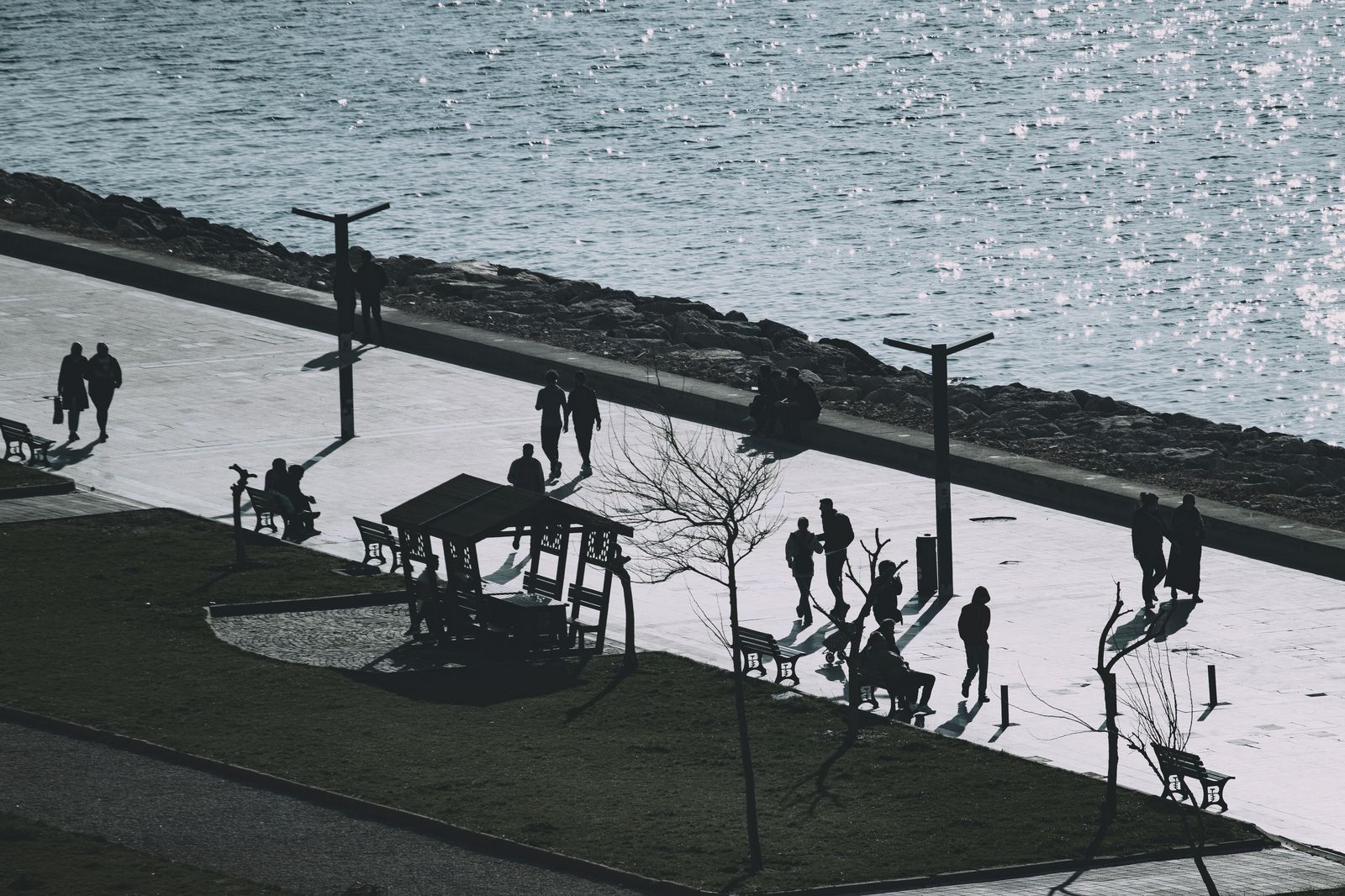 People walking along the Queens Quay waterfront near the ferry terminal
