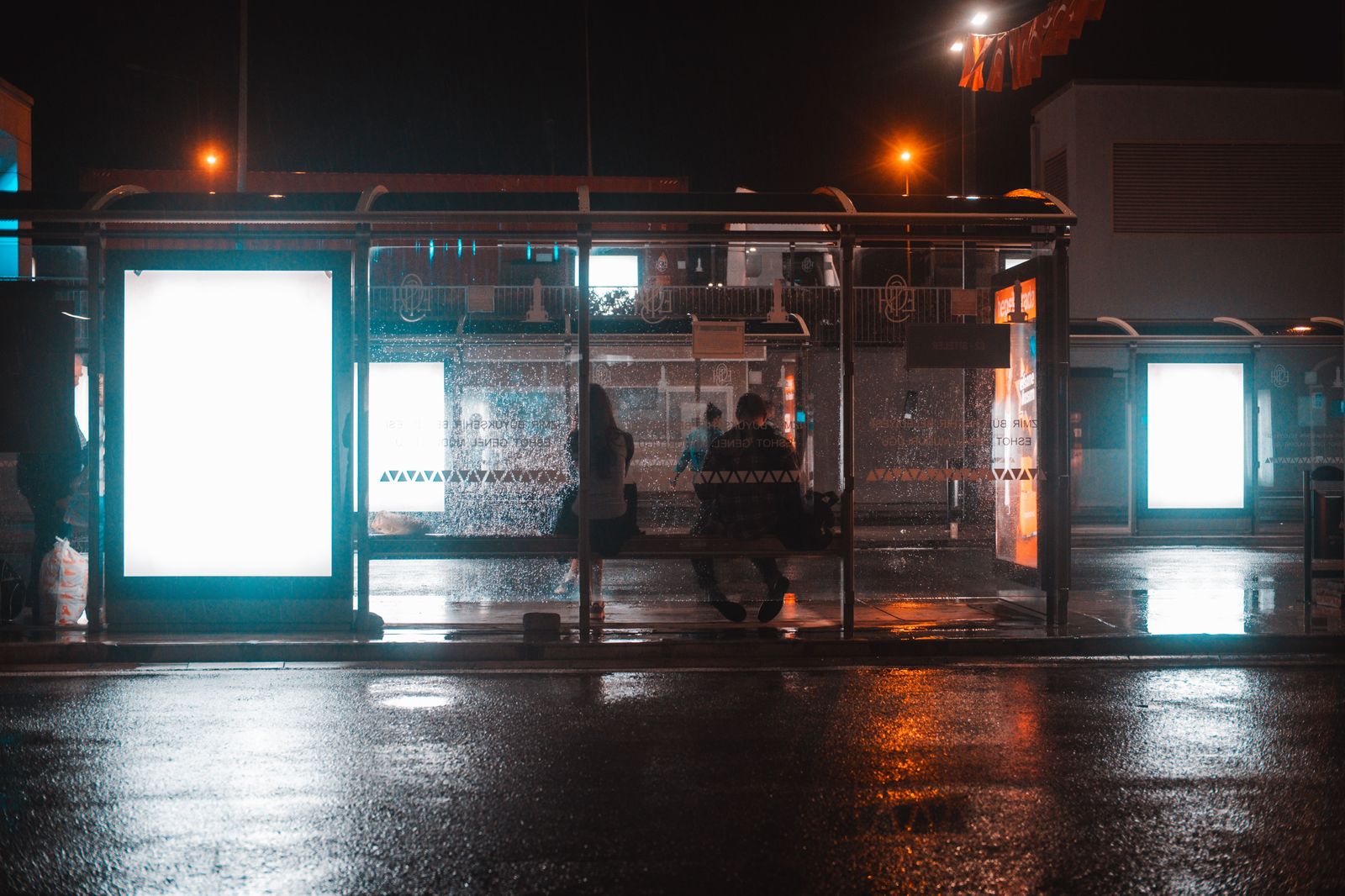 Travellers waiting with luggage at a bus terminal, the start of the budget route to Pearson