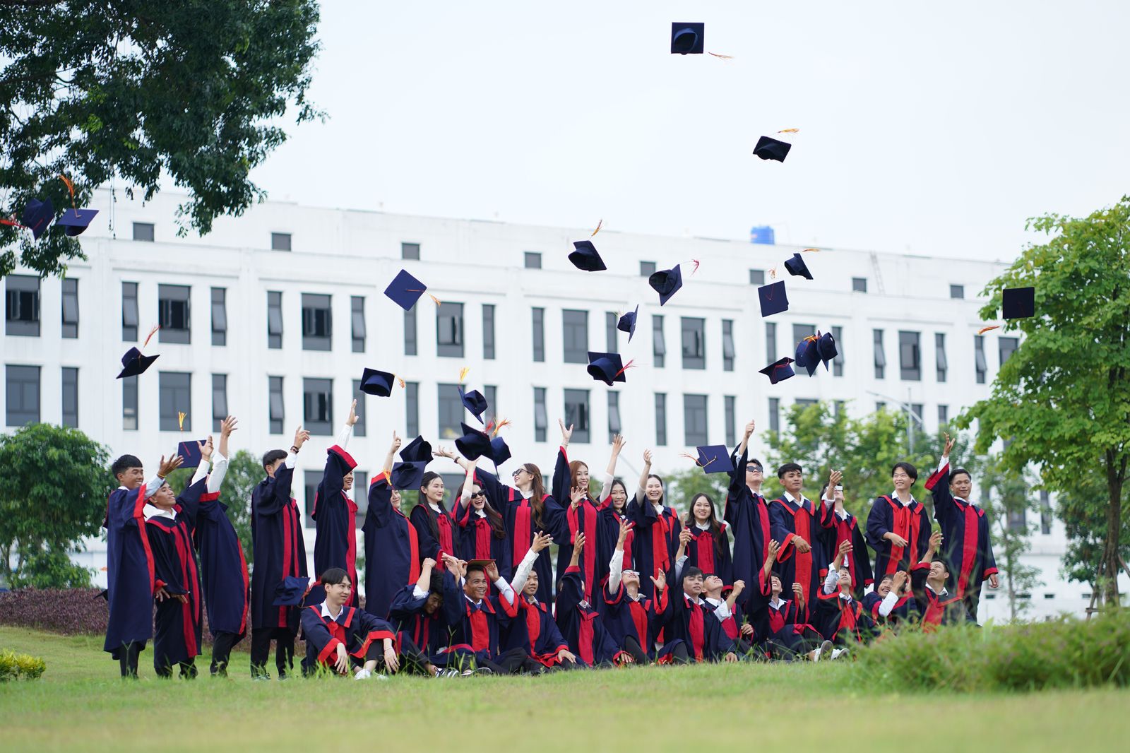 Graduates celebrating at convocation, a busy week for Kingston airport transfers