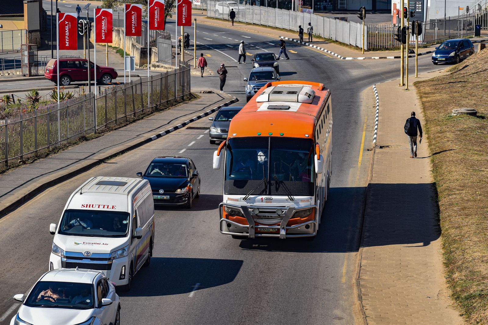 An airport shuttle at a terminal curb, the scheduled option between London and Pearson