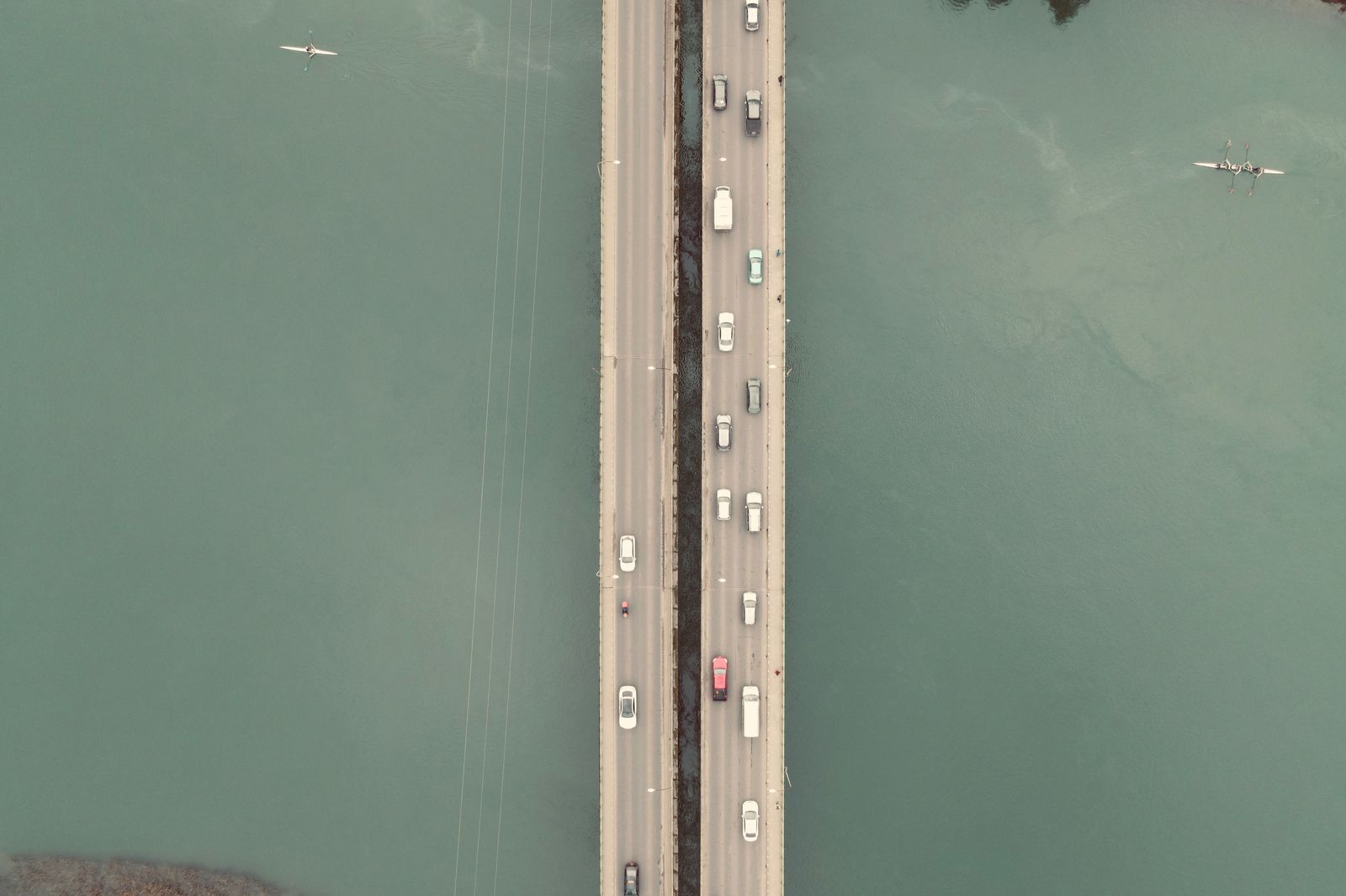 Cars queued at a border crossing bridge in the late afternoon
