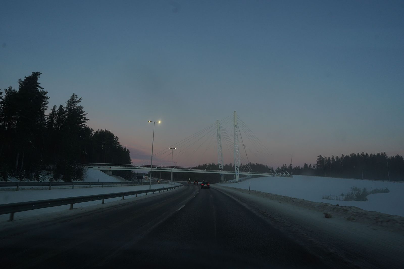Highway traffic in falling snow at dusk, the conditions that stretch a north-end airport run