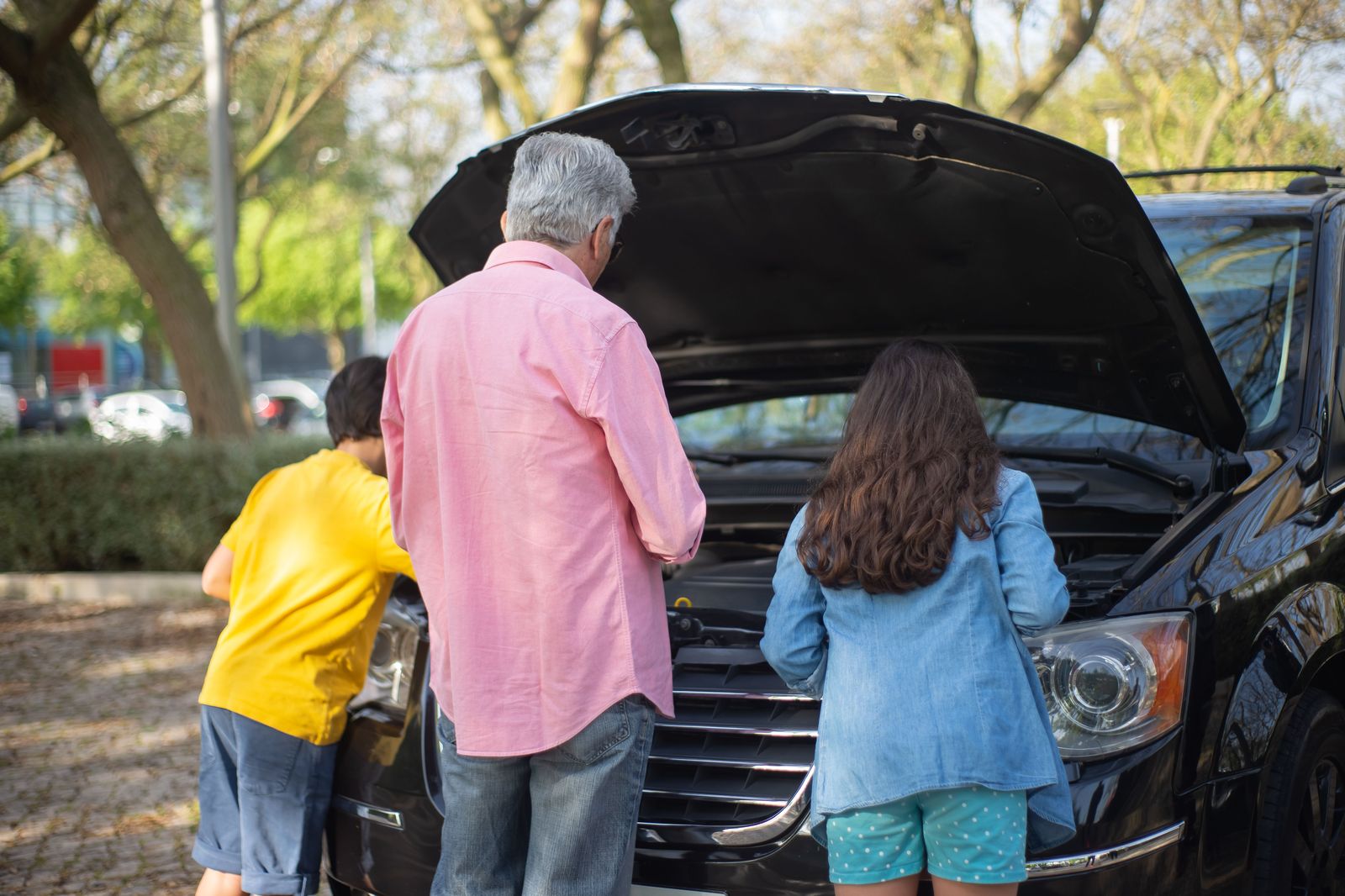 A family loading suitcases into a minivan, the point where a shared car starts to compete