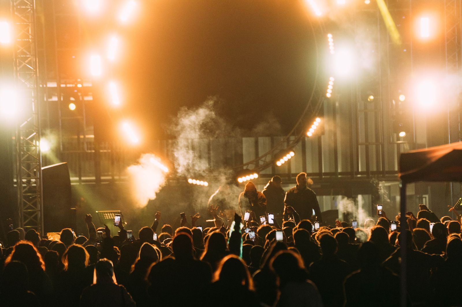An outdoor concert crowd at dusk, the kind of evening a chauffeured car makes easy