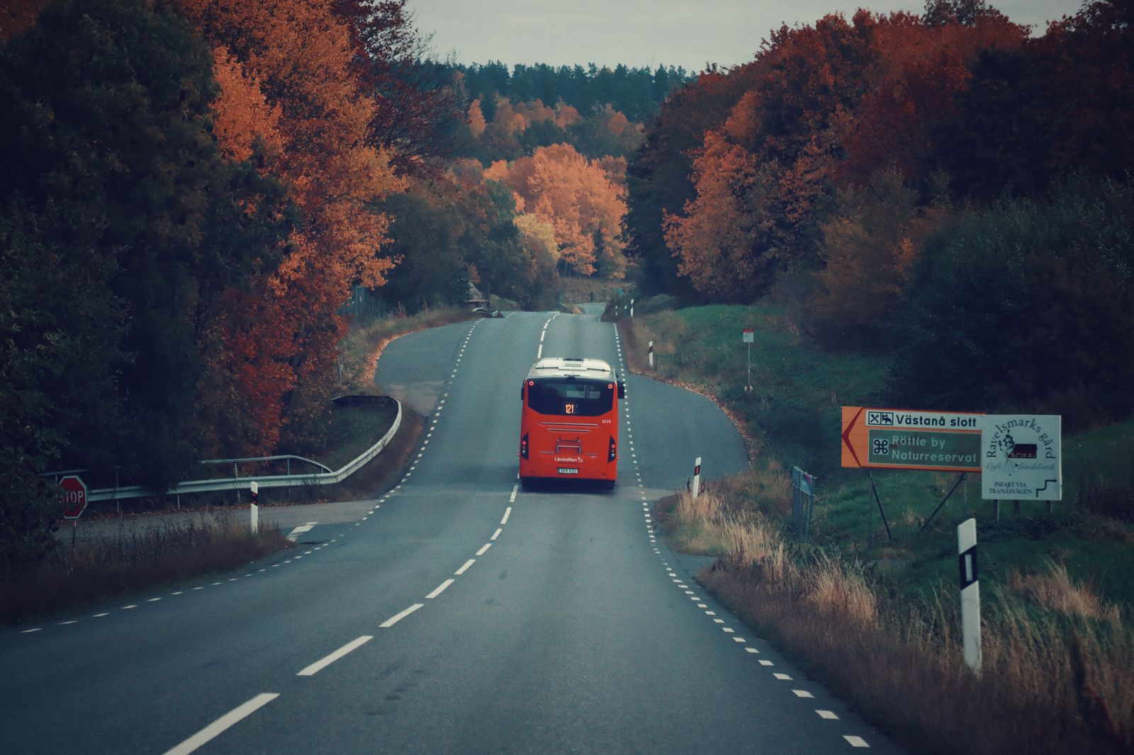 A coach bus travelling along a highway in daylight