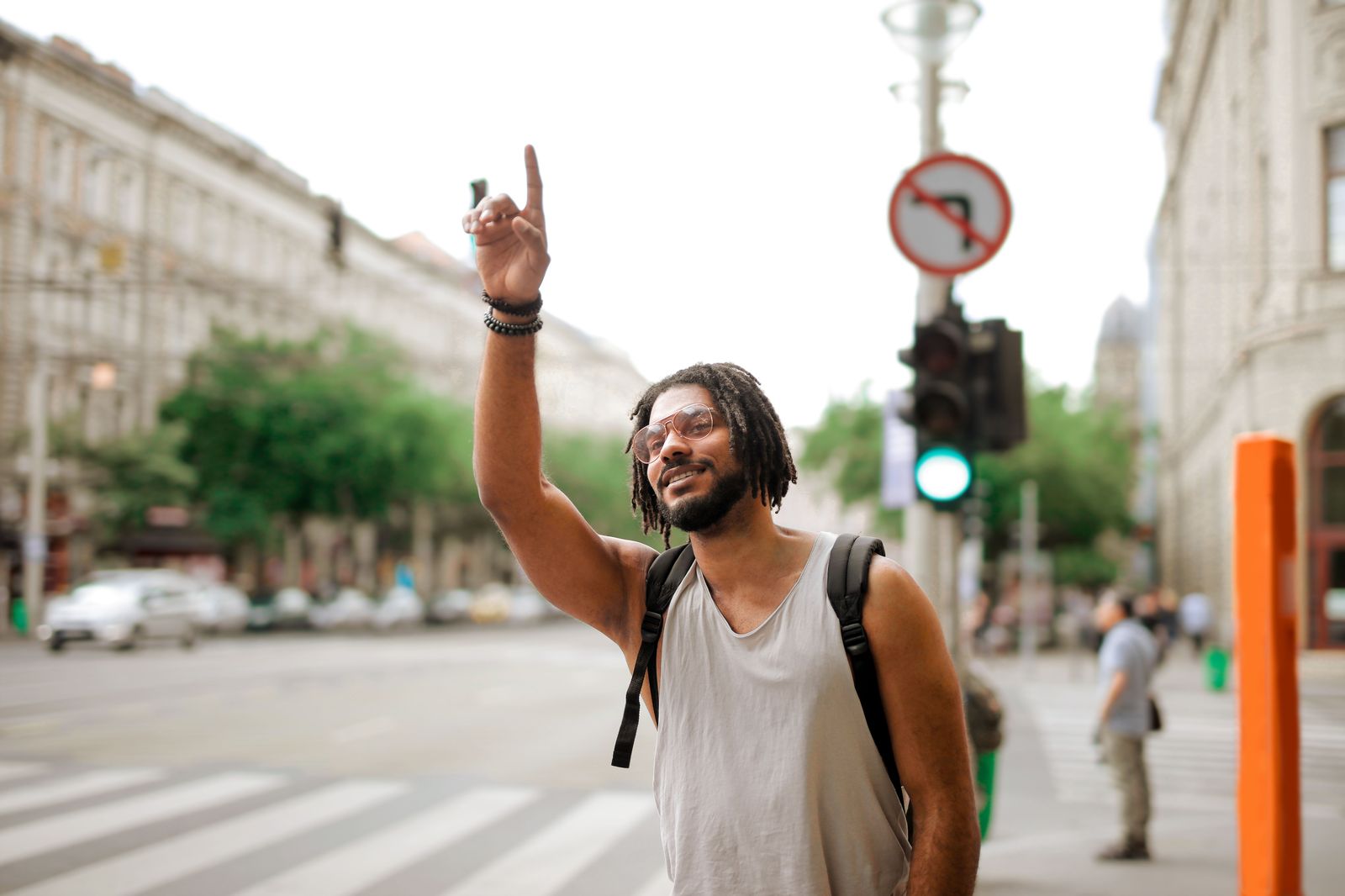 A traveller hailing a taxi on a busy downtown street