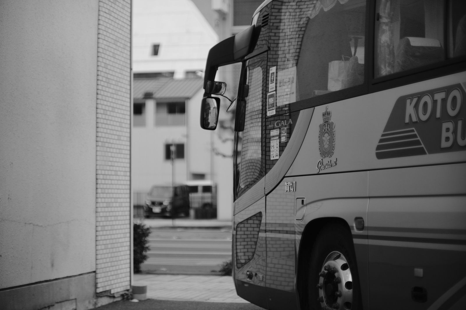 A city bus at a stop, one of the transit routes that serve the airport