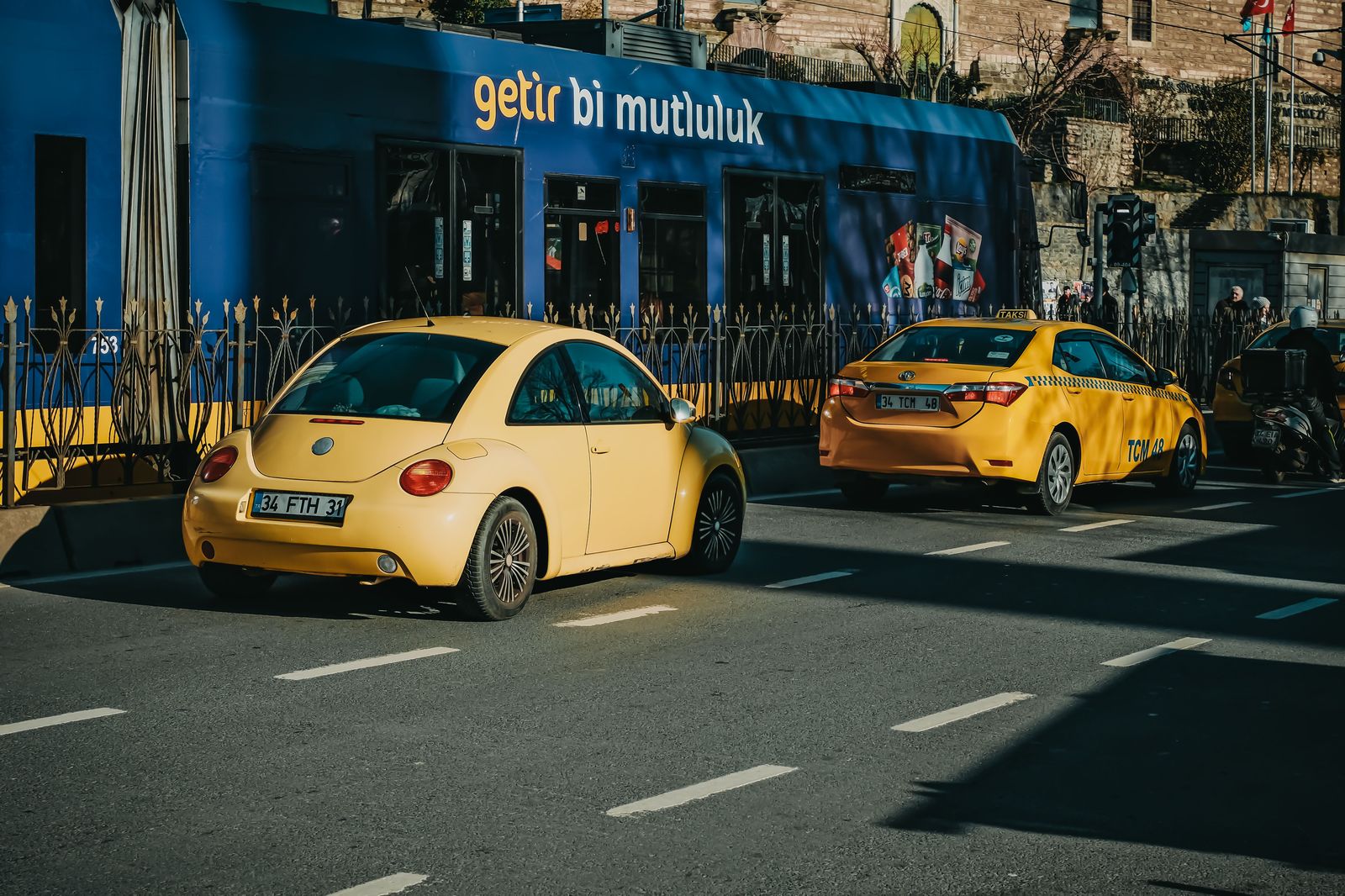 A taxi driving along a downtown Toronto street at dusk