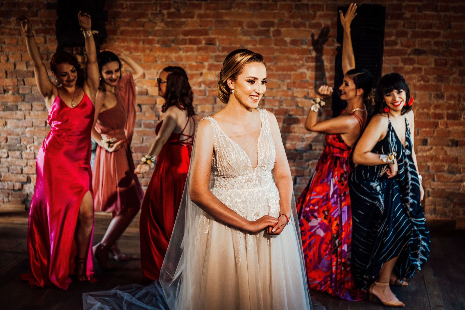 Bridesmaids celebrating together beside a white limousine