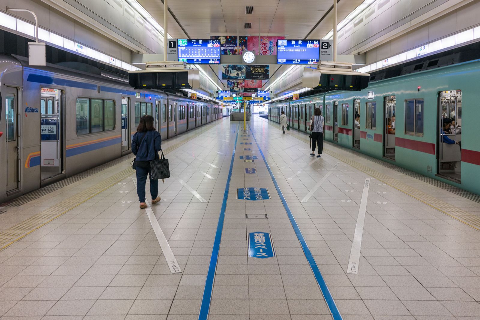 A commuter train waiting at a platform in a downtown station