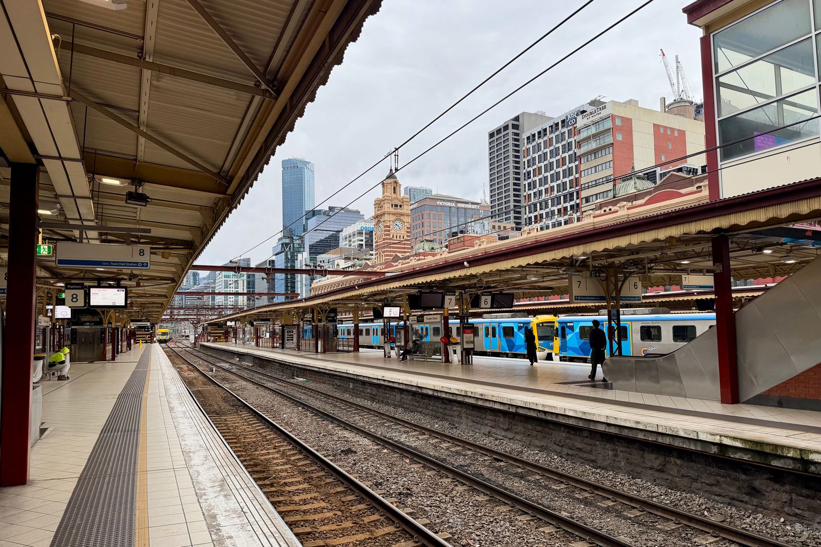 A commuter train at a city platform, the rail link many solo travellers use from Pearson