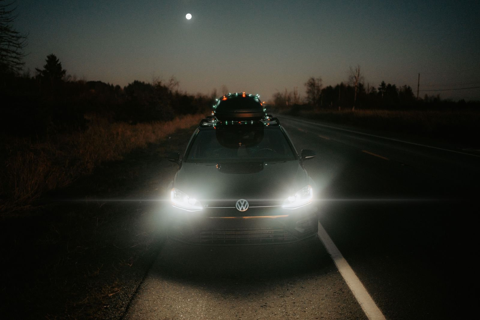 A black SUV on a highway at night heading from Pearson to Brampton
