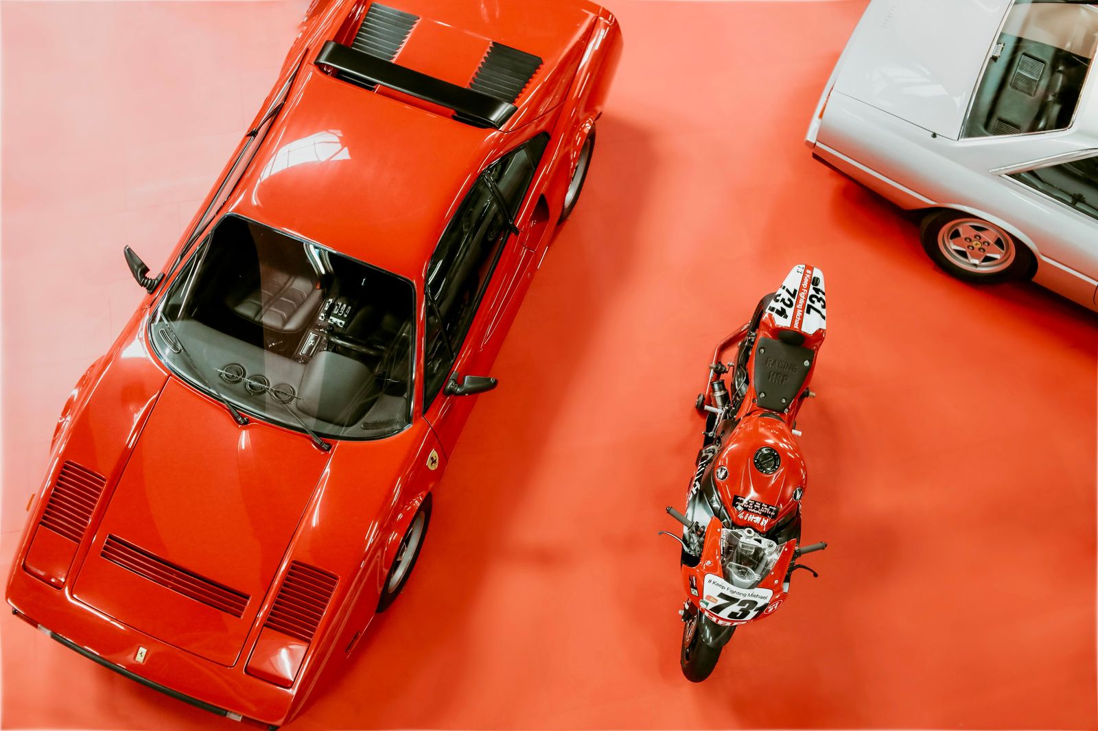A sports car under show lights on a convention-centre display floor