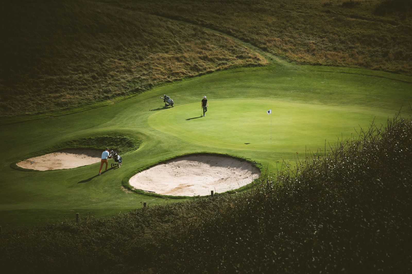 Spectators lining a fairway at a professional golf tournament