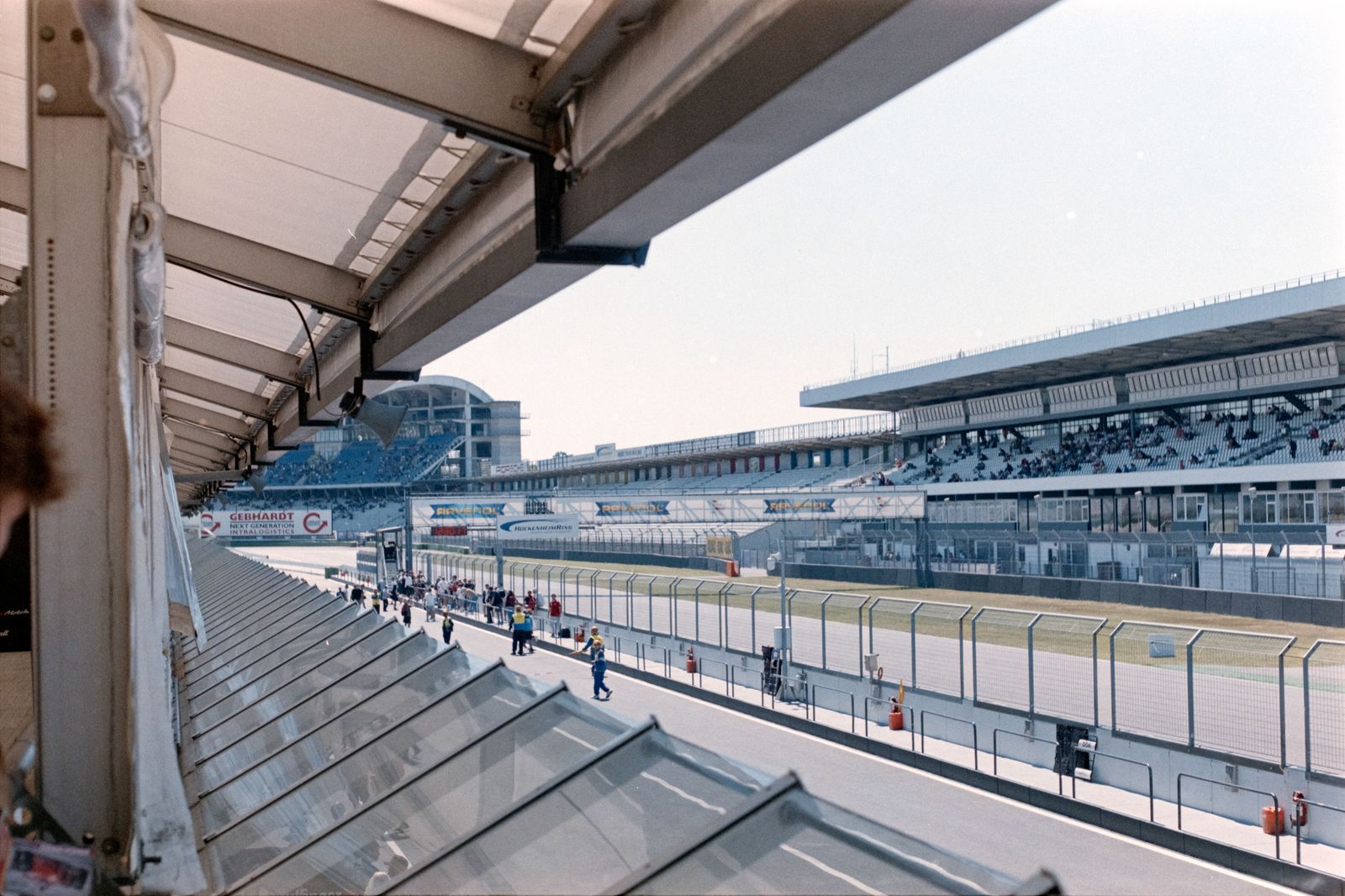 Grandstand crowds watch IndyCars on a temporary street circuit