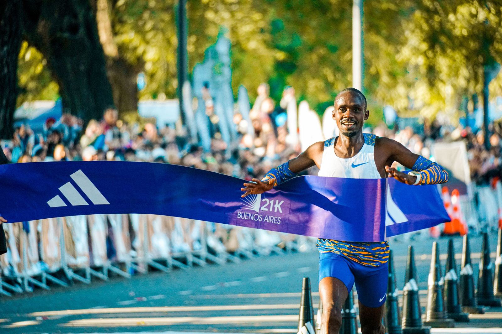 Runners cross the finish line in front of Toronto City Hall