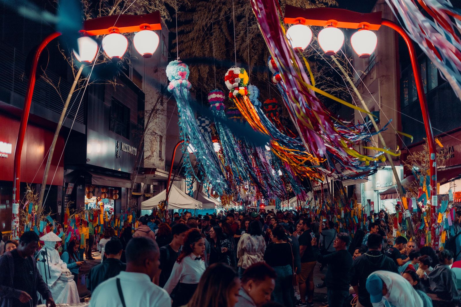 Crowds on a closed downtown street at night during an all-night art festival