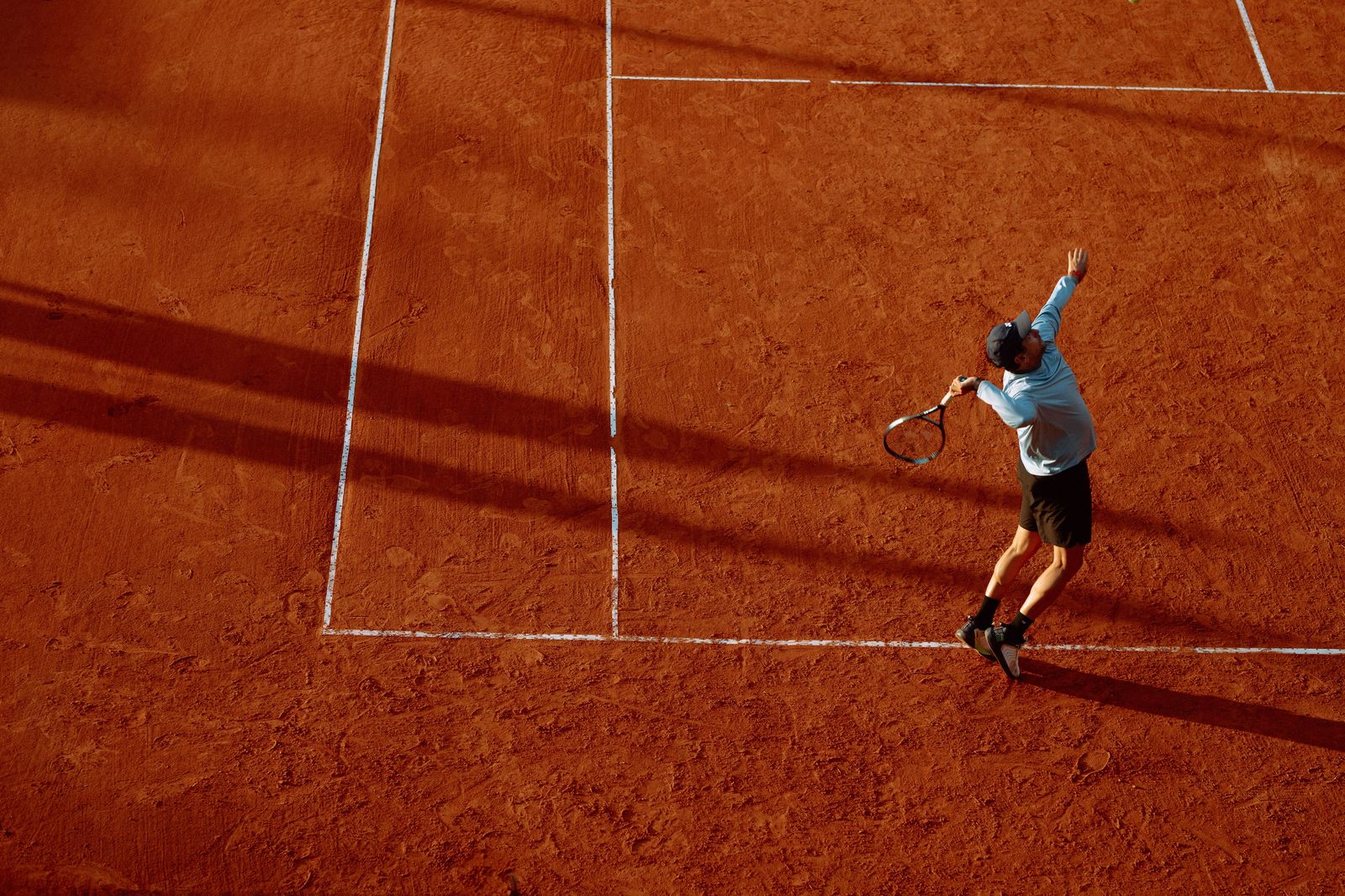 A hard-court serve at a summer tournament: day sessions start late morning and night sessions can run close to midnight