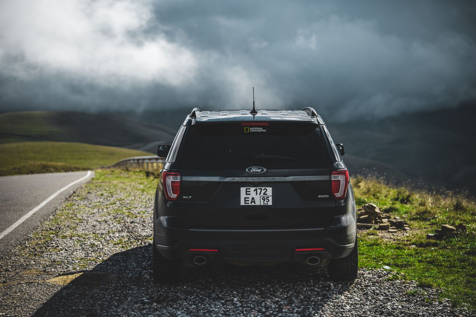 A black executive SUV on Highway 401 east of Toronto in morning light