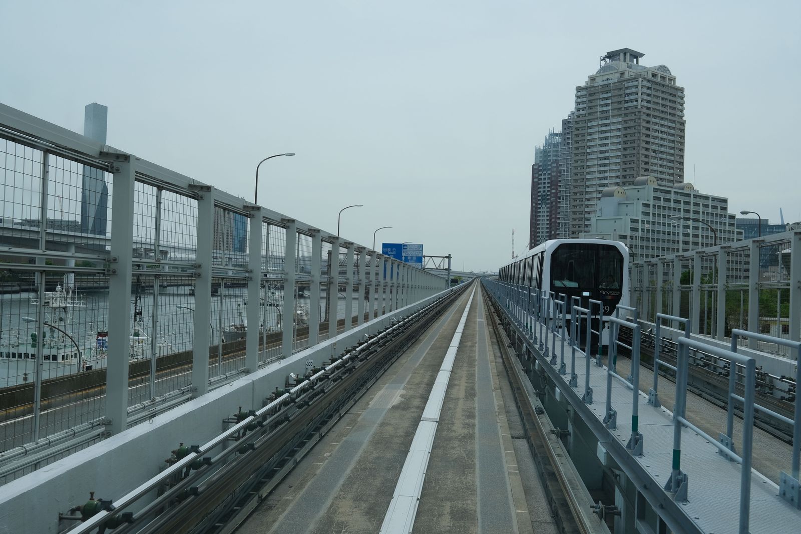 An automated airport people mover train arriving at a station