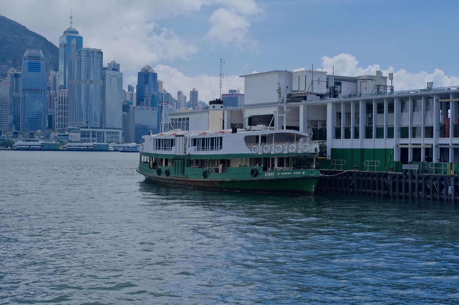 A small passenger ferry crossing a short harbour channel