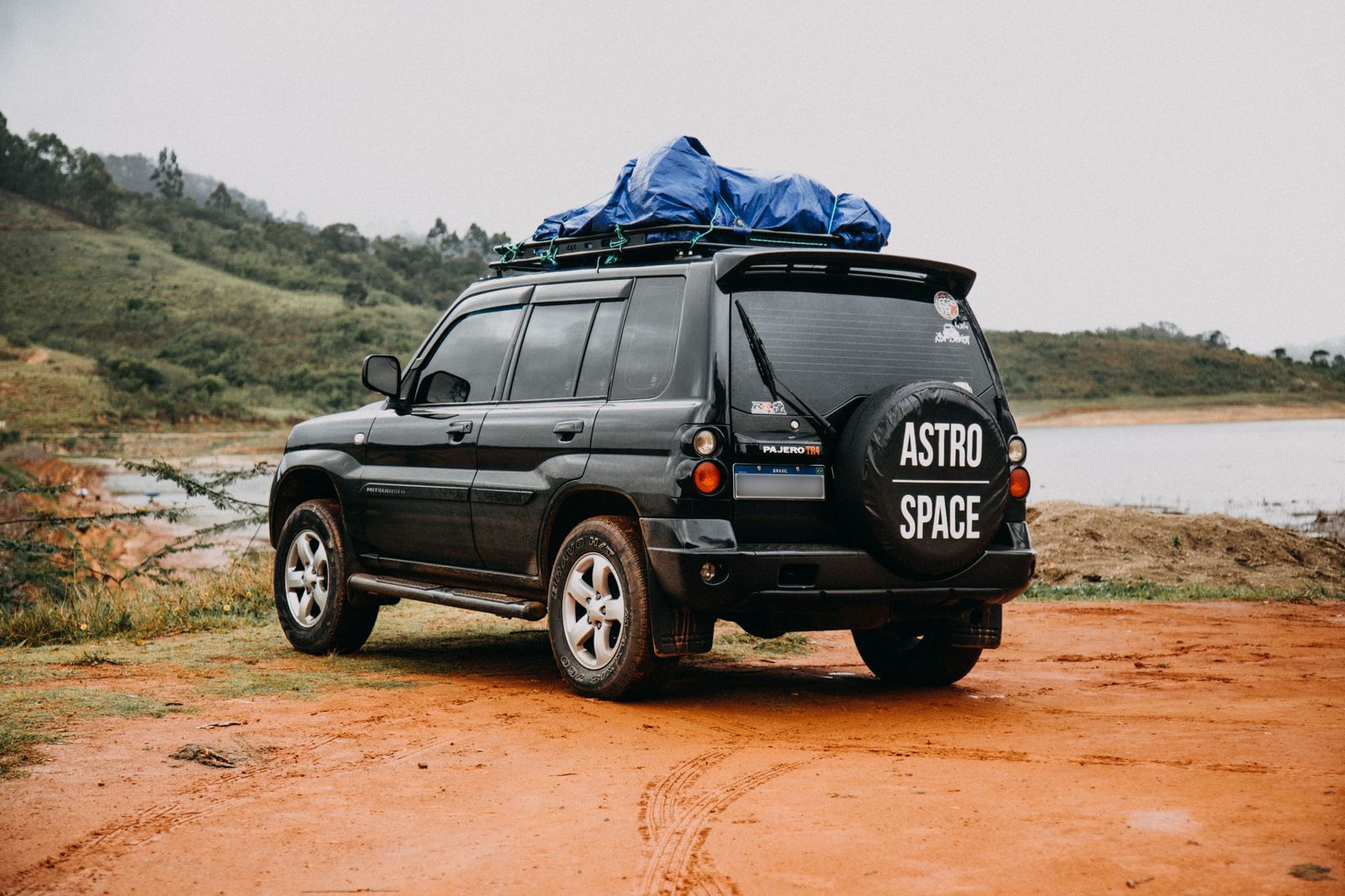 A black SUV waiting near a location basecamp for a talent return