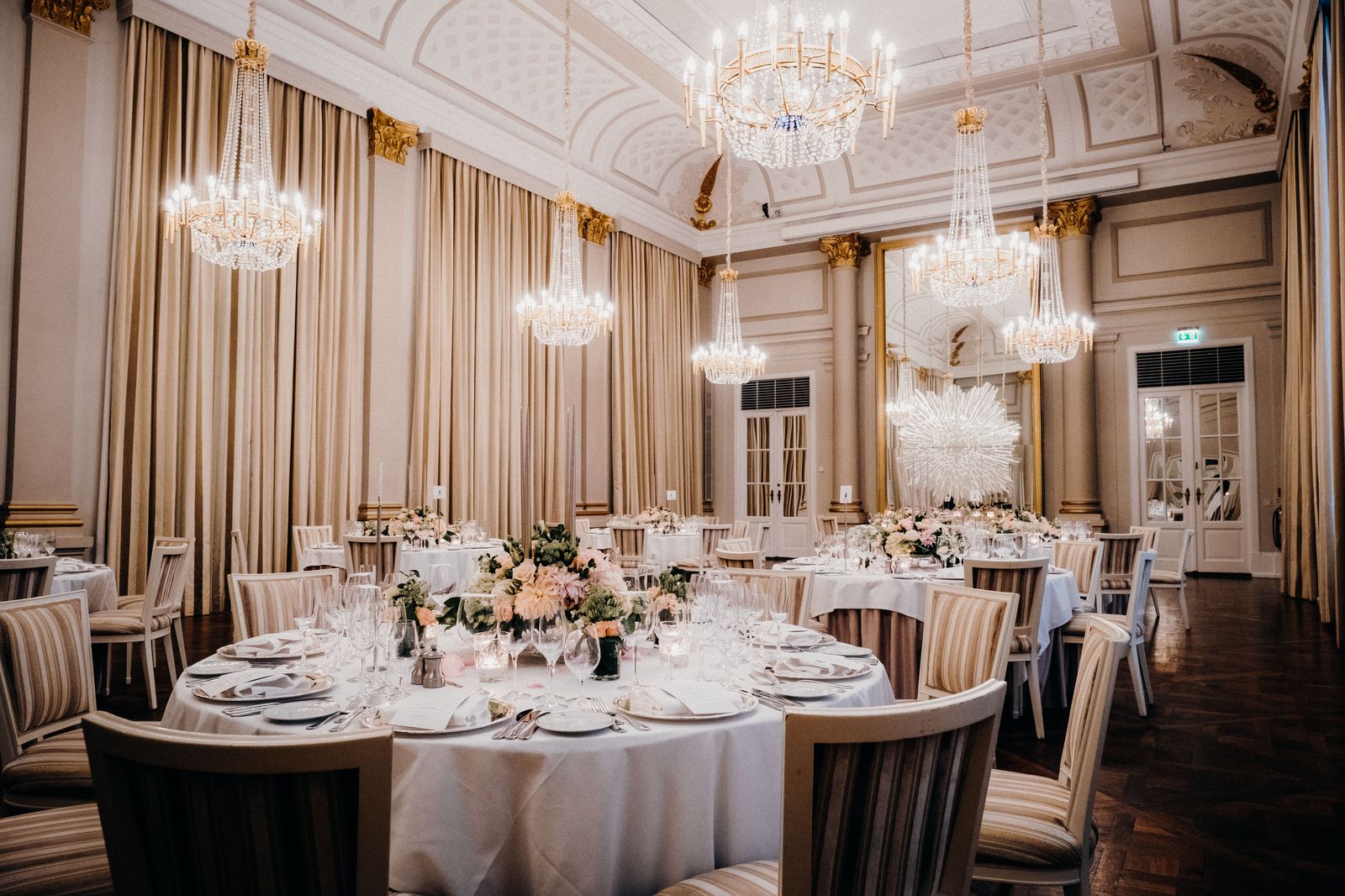 A ballroom set for a corporate awards dinner, with the room ready before the first car pulls up