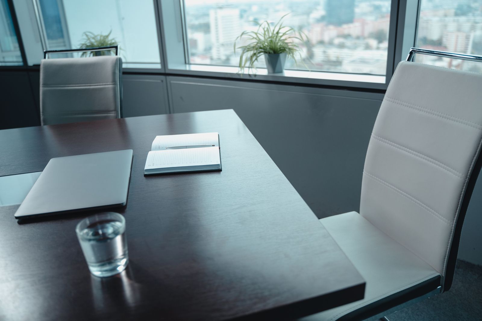 A boardroom table overlooking the downtown core between investor meetings