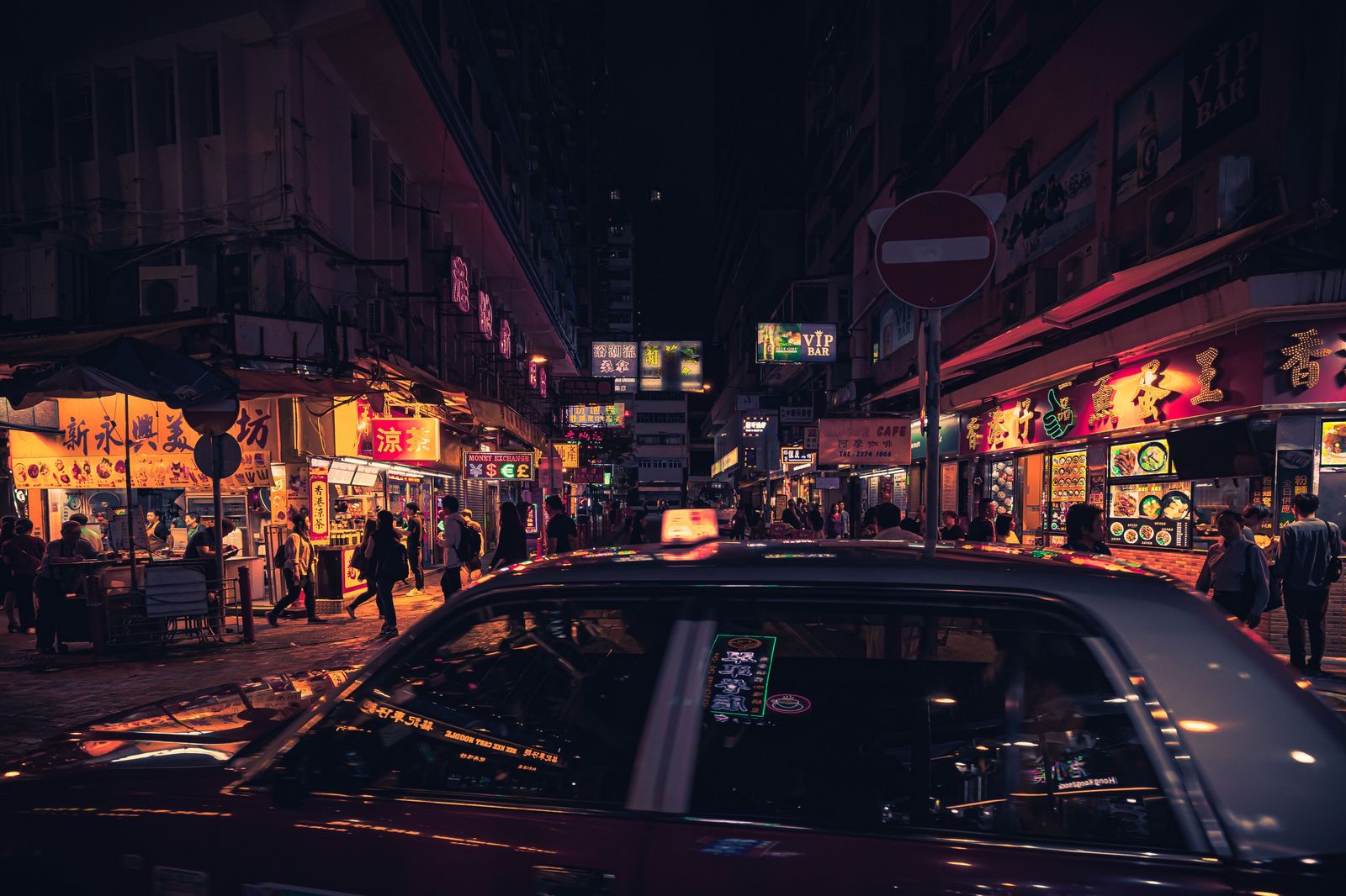 A black sedan waiting on a downtown Toronto street at night, the usual end point of a Pearson transfer