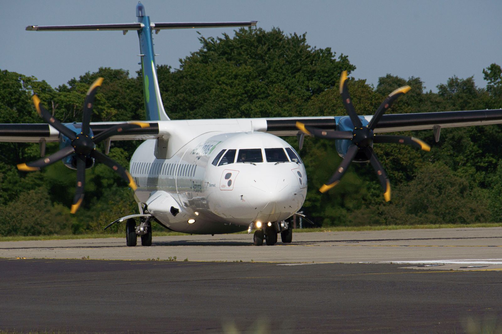 A turboprop aircraft on a runway beside the lake, typical of flights from the island airport