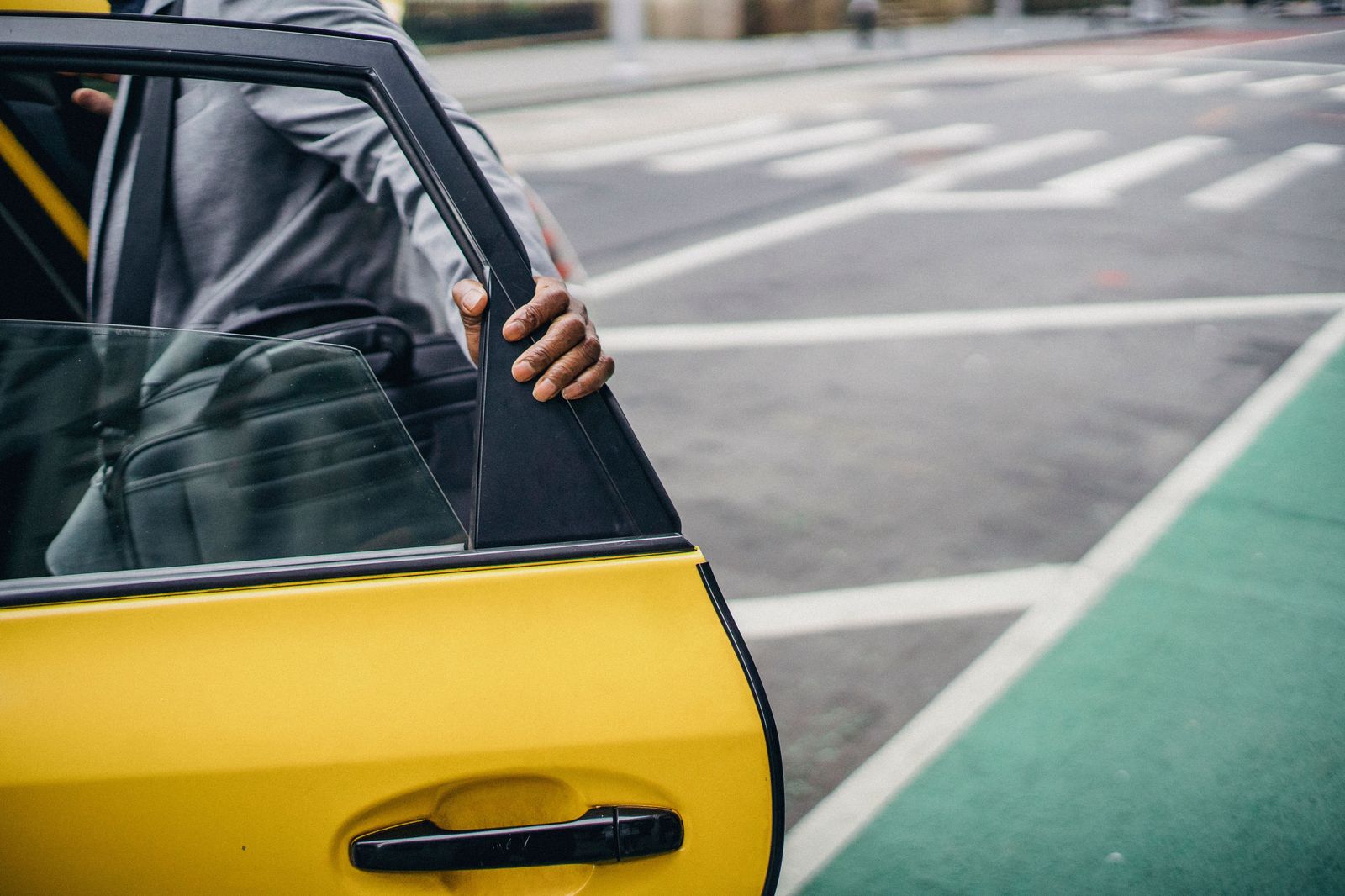 Chauffeur holding a car door open for a business traveller