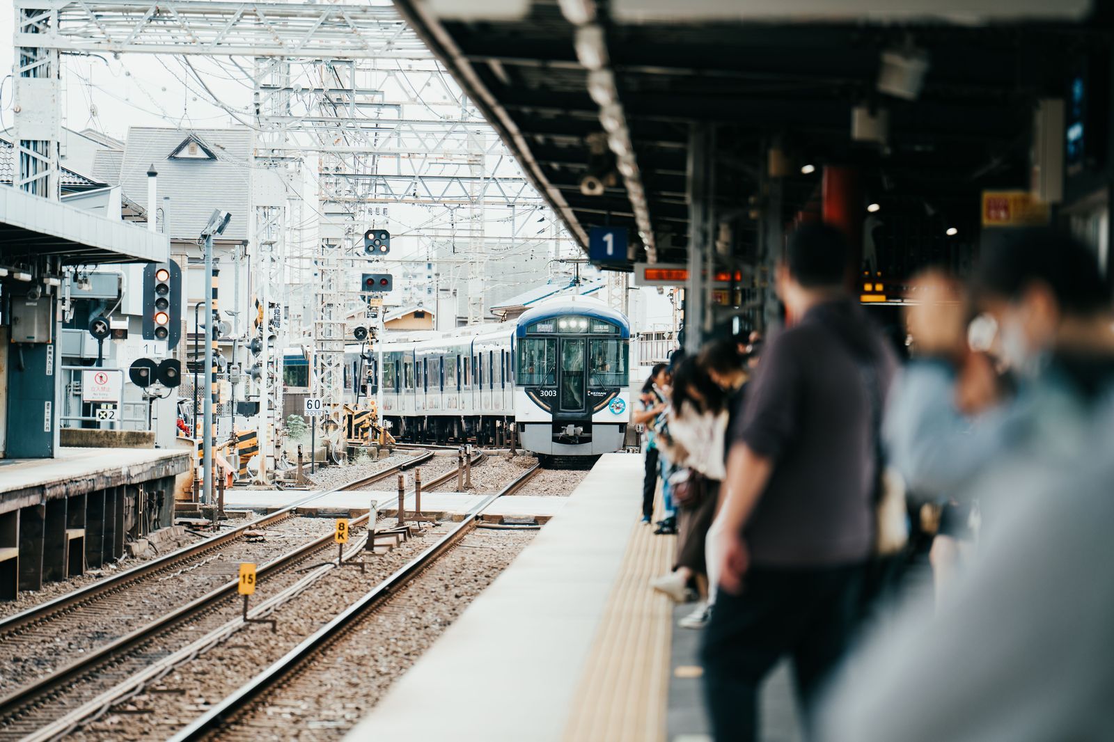 Passenger train arriving at a station platform, timed by live tracking before the chauffeur's pickup