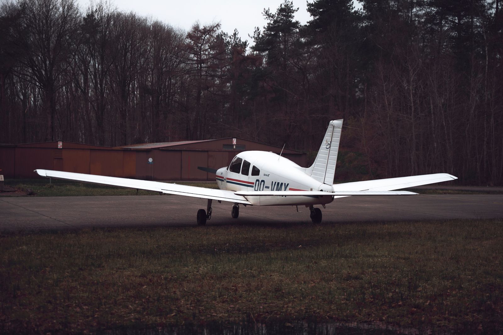 Small airport runway with a light aircraft, similar to Oshawa Executive Airport's general aviation traffic