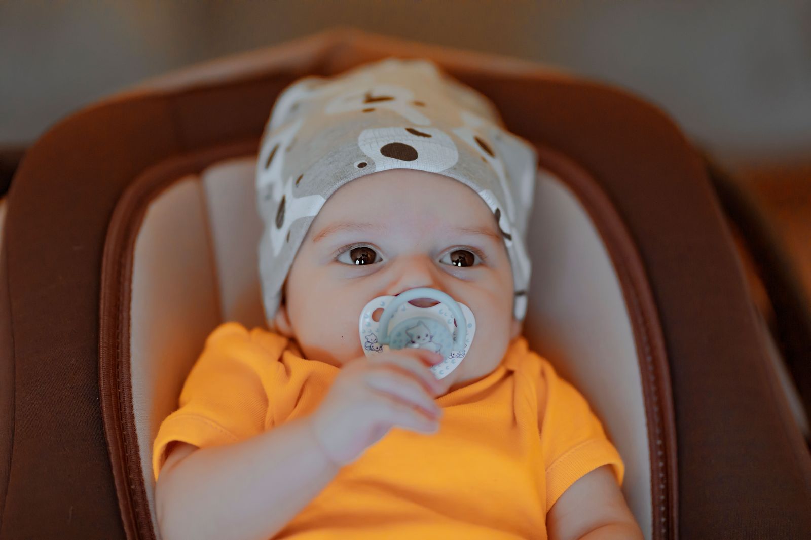 A rear-facing infant car seat installed in the back seat of a car